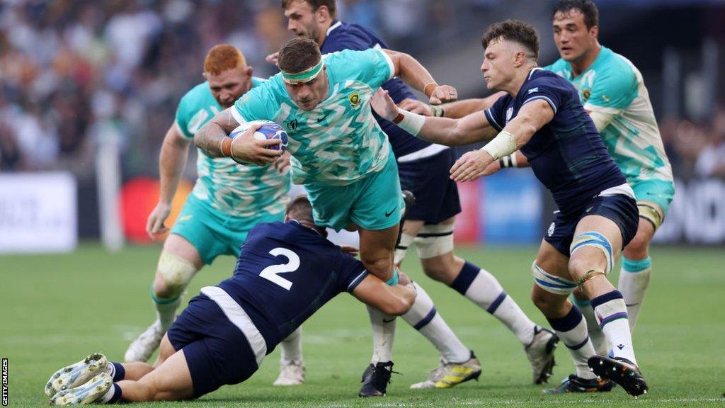 Malcolm Marx of South Africa is tackled by George Turner of Scotland