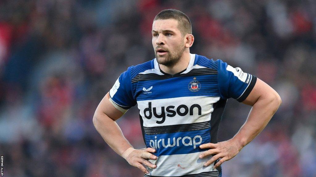 Charlie Ewels stands with his hands on his hips on the pitch during a Bath game