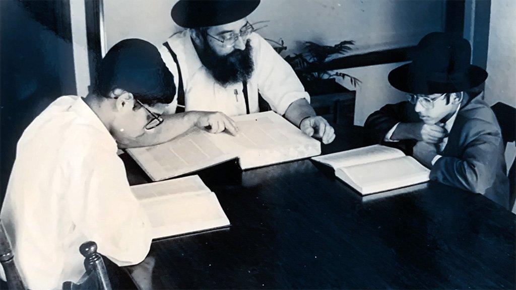 Manny as a boy (left) studying religion at home