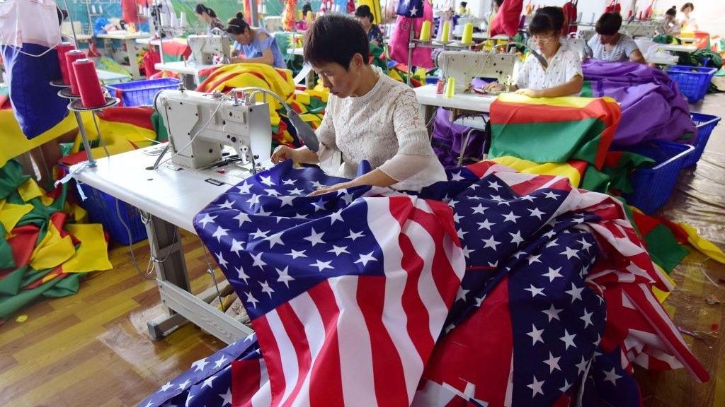 Chinese employees sew US flags at a factory in Fuyang