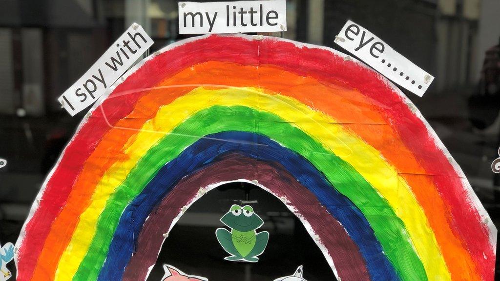 A vetinary shop window displays a rainbow poster in support of the NHS