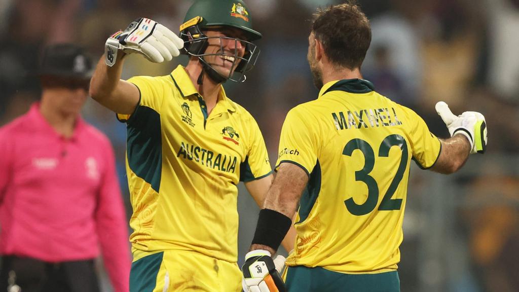 Australia's Pat Cummins (left) and Glenn Maxwell (right) embrace