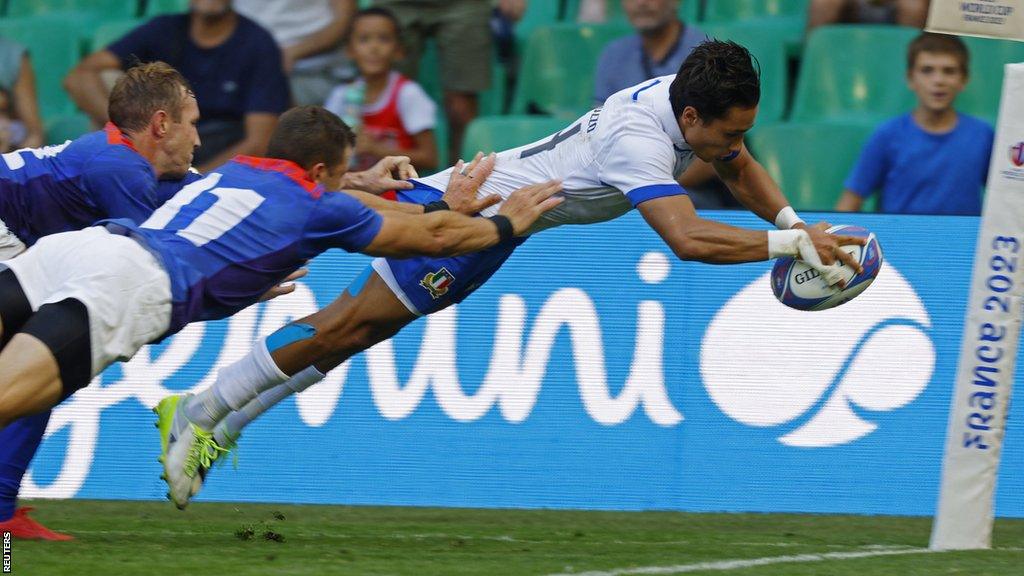 Italy's Ange Capuozzo scores a try