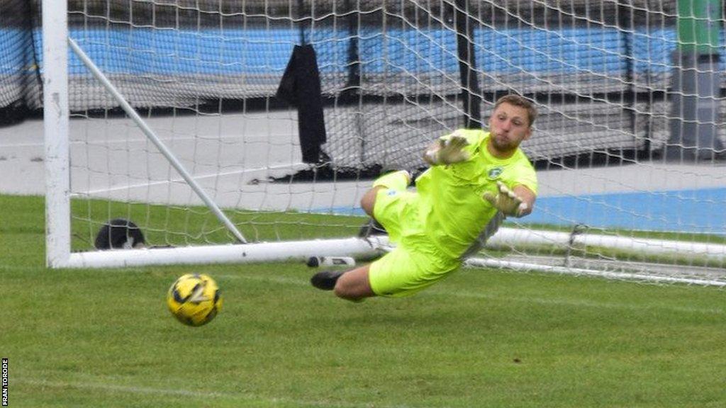 Josh Addison saves a shot for Guernsey FC