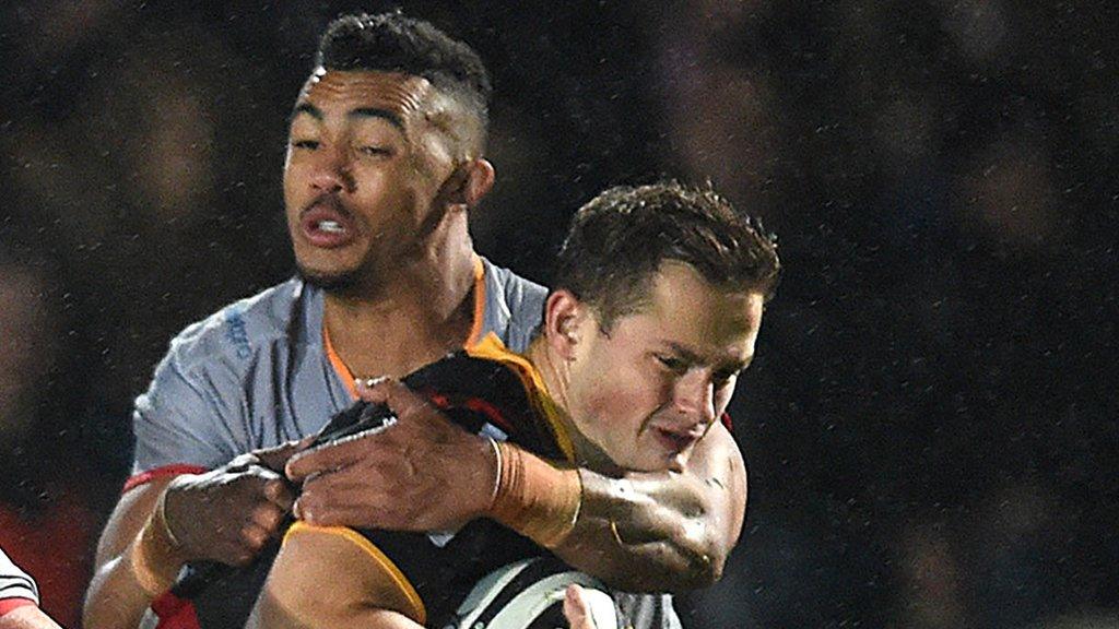 Hallam Amos of Dragons is tackled by Bobby de Wee