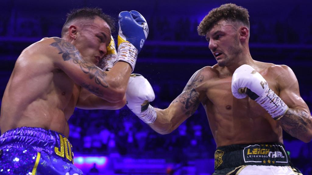 Josh Warrington is punched by Leigh Wood