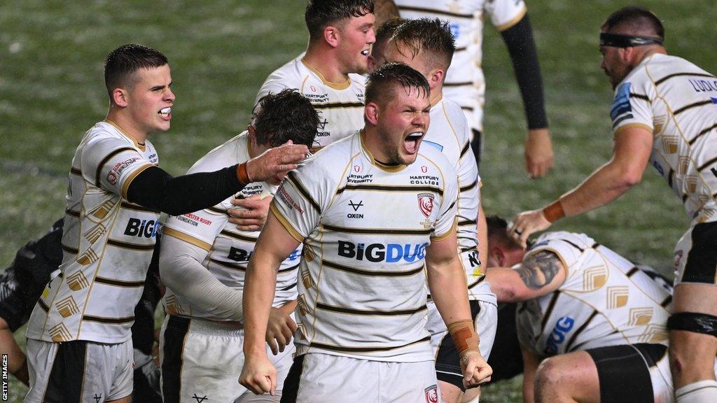 Freddie Clarke (centre) leads the Gloucester celebrations after their victory over Newcastle Falcons