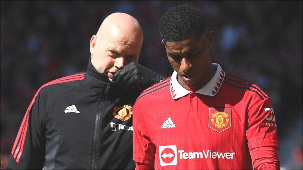 Marcus Rashford leaves the pitch with the Manchester United physio at Old Trafford