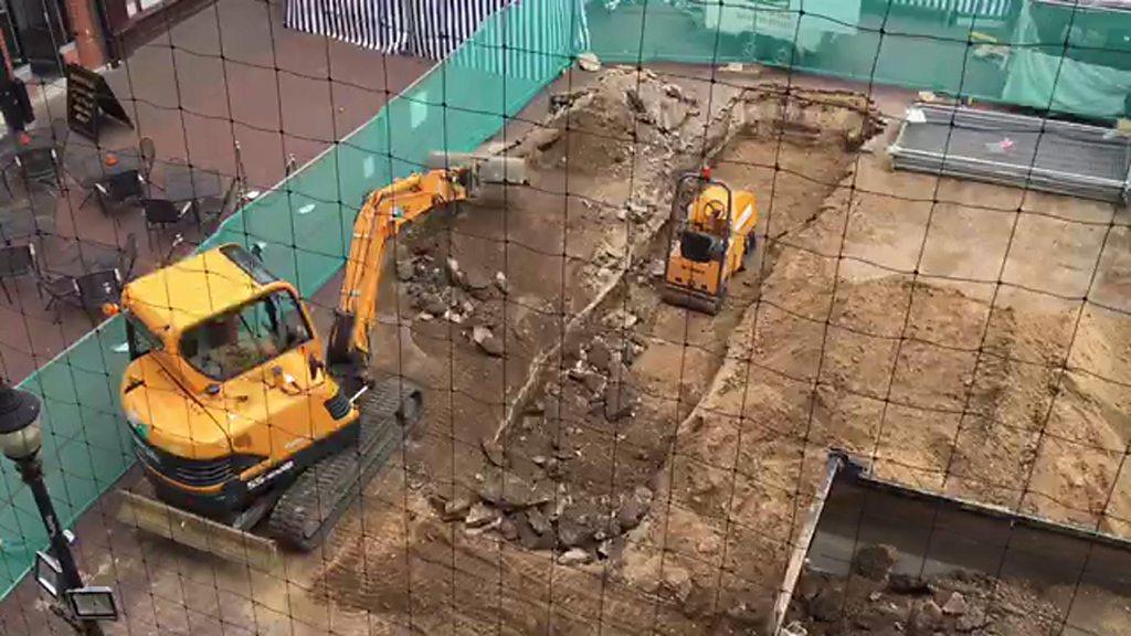 Diggers carving out trenches for archaeological dig