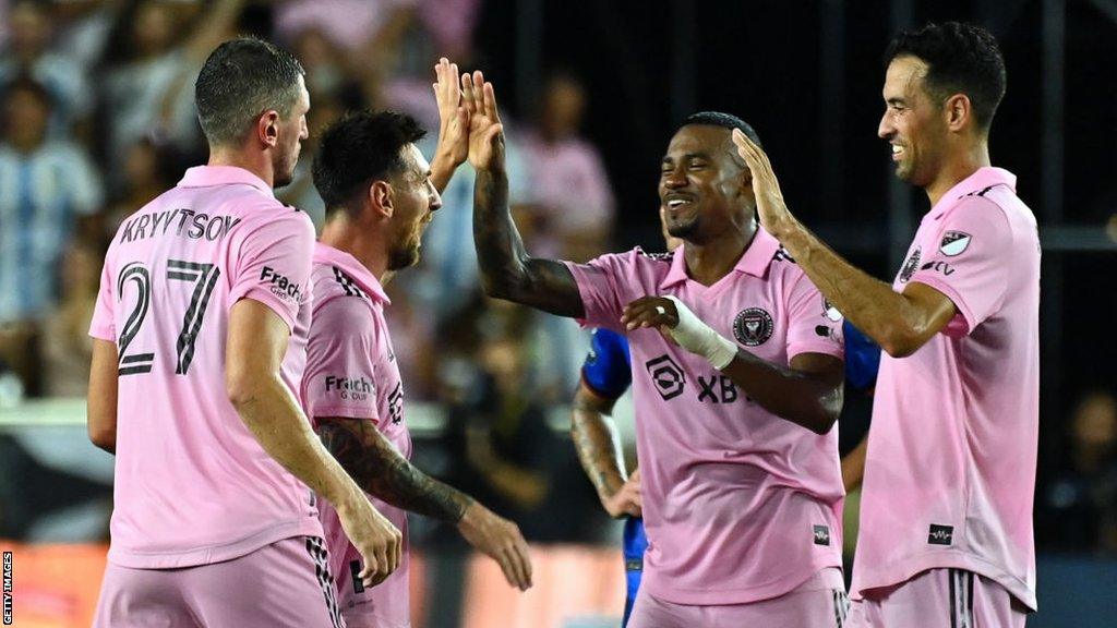 Lionel Messi and Sergio Busquets celebrate with their Inter Miami team-mates.