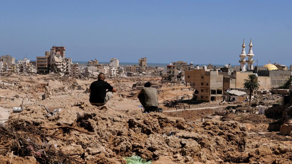 People look at the damaged areas of Derna, Libya