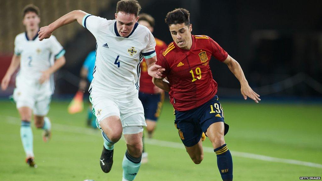 Kofi Balmer (left) playing for Northern Ireland under-21s against Spain in a European Championships qualifier