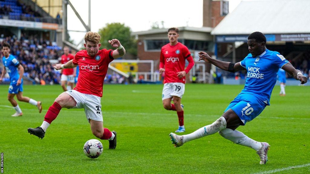 Jasper Pattenden tries to block a cross by Ephron Mason-Clark