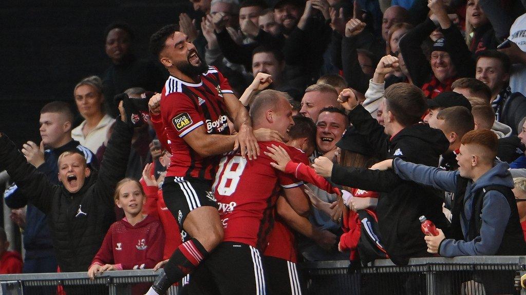 Paul Heatley celebrates with Crusaders fans after scoring the winner at Seaview