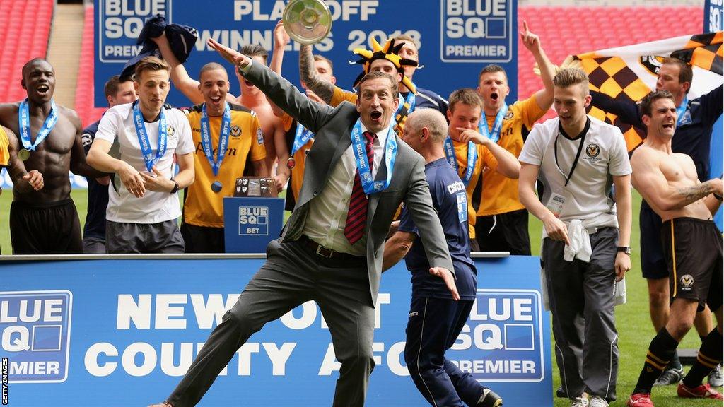 Justin Edinburgh and Newport County's players celebrate victory over Wrexham