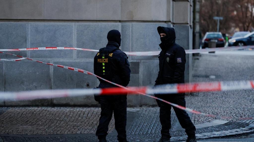 Police stand guard following a shooting at one of Charles University's buildings in Prague