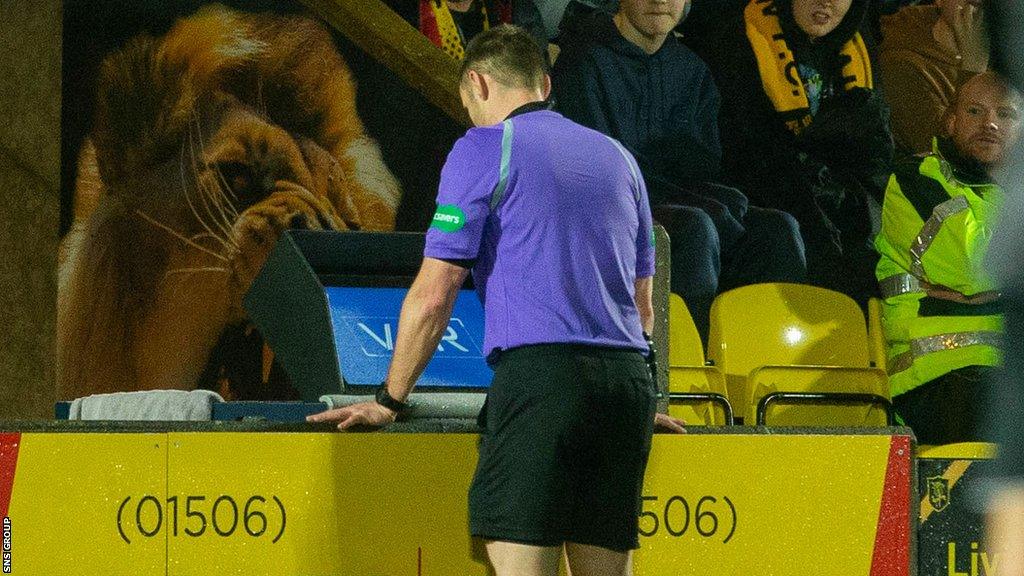 Referee Steven McLean checks VAR for a possible red card for Scott Pittman during a cinch Premiership match between Livingston and St. Mirren