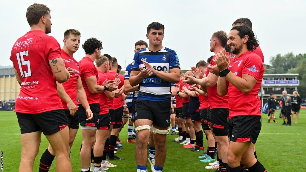 Jersey Reds players clap Bath off the field after beating them