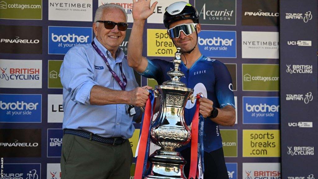 Mick Bennett presents Gonzalo Serrano with the Tour of Britain trophy