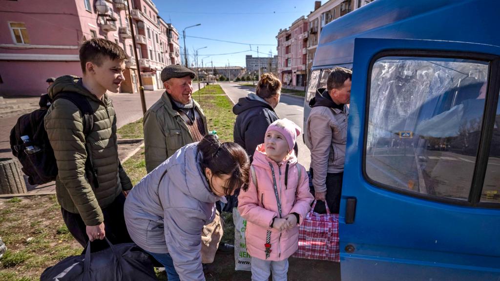 People wait for a bus a day after a rocket attack at a train station, in Kramatorsk, on 9 April 2022