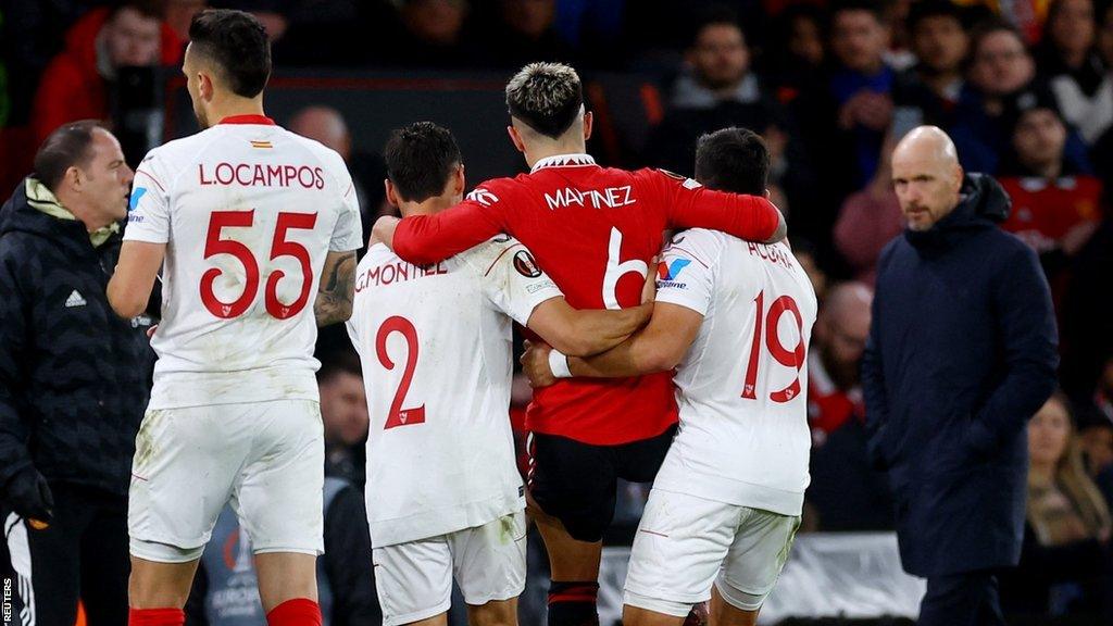 Manchester United's Lisandro Martinez is helped off the pitch during the Europa League match with Sevilla