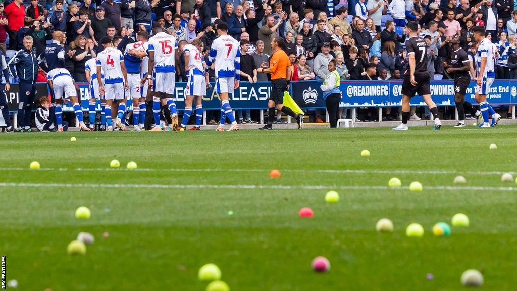 Players were forced to leave the pitch after fans threw tennis balls onto the ground in protest against Reading's owners