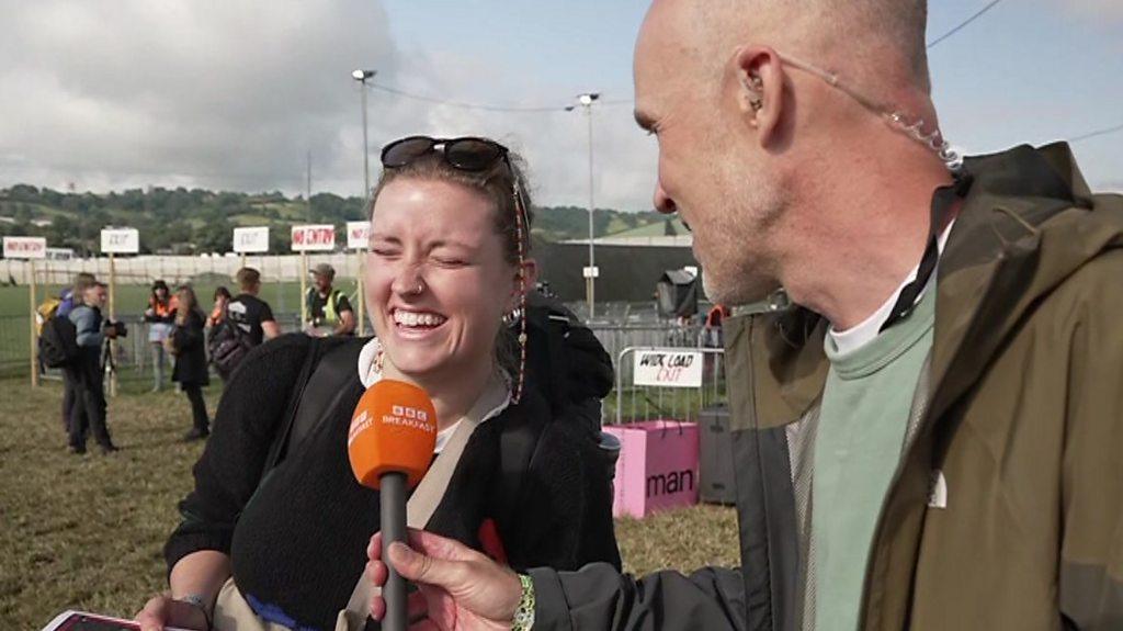 Girl laughing into microphone