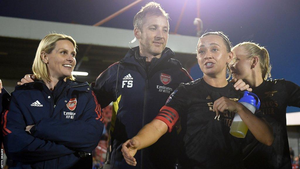 Kelly Smith and Katie McCabe in a team huddle