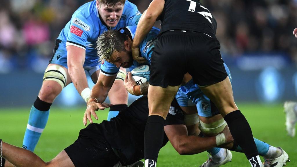 Josh Turnbull of Cardiff is tackled by Nicky Smith of Ospreys
