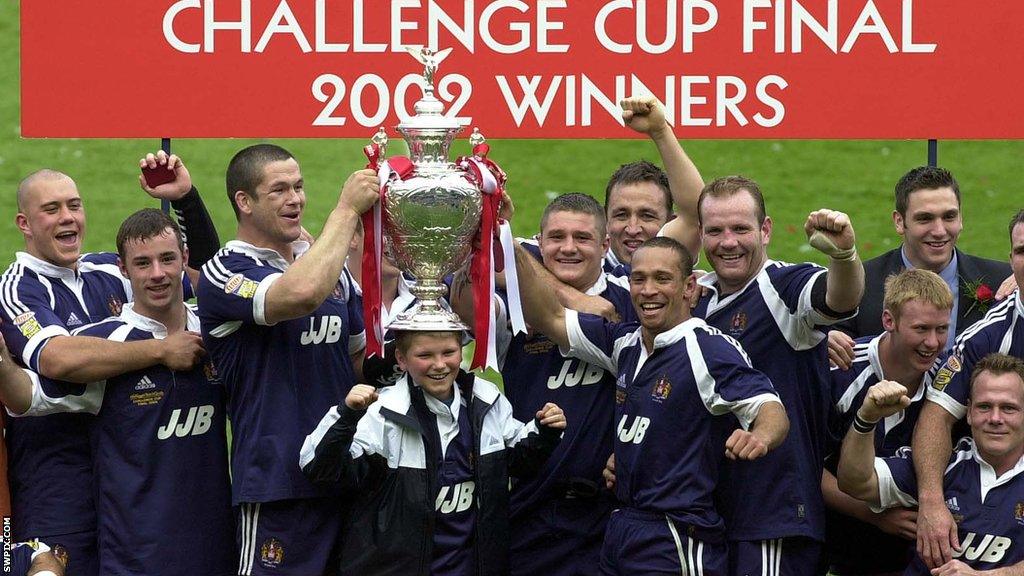 Adrian Lam was part of a Wigan side that won in 2002, helping to celebrate with the trophy after their win over St Helens