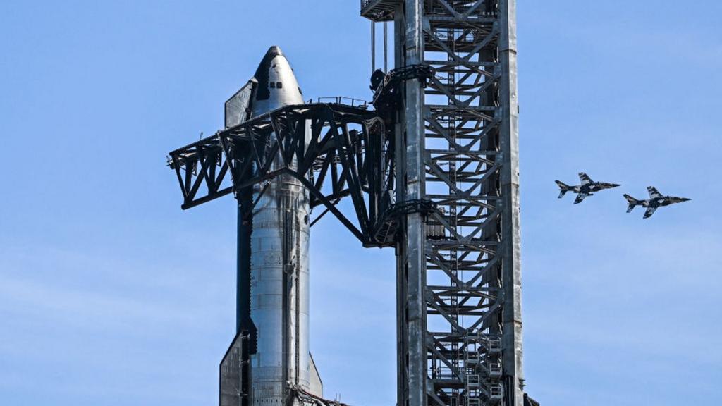 US billionaire businessman and pilot Jared Isaacman flies in formation aboard a fighter jet over the SpaceX Starship spacecraft, before his third test flight from Starbase in Boca Chica, Texas, on March 13, 2024.