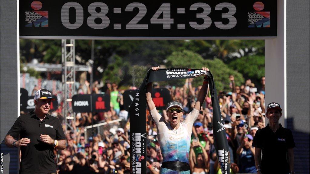 Lucy Charles-Barclay celebrating as she crosses the finish line