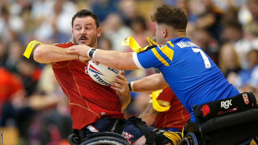 Seb Bechara is tackled by Tom Halliwell