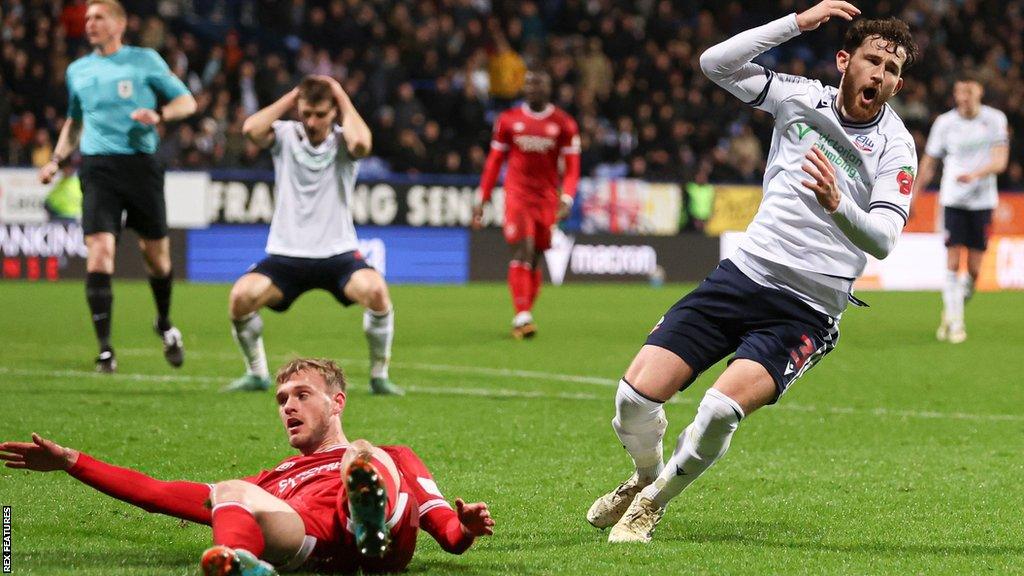 Bolton players react to a missed chance against Shrewsbury