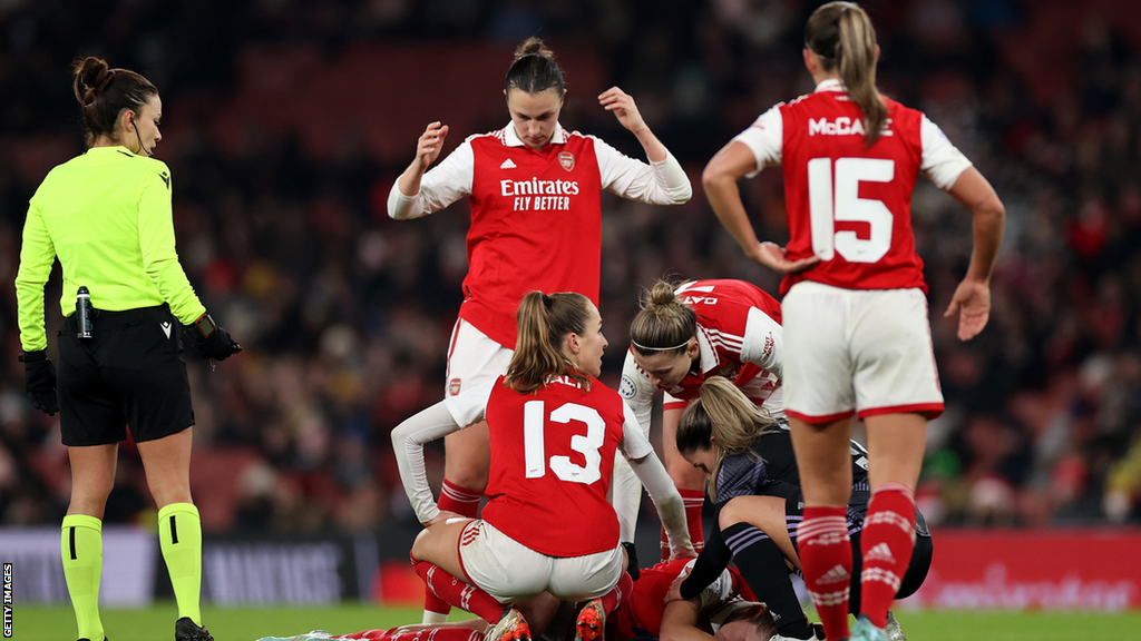 Vivianne Miedema of Arsenal lies on the ground after picking up a serious leg injury during the Women's Champions League group match against Lyon at Emirates Stadium on 15 December 2022