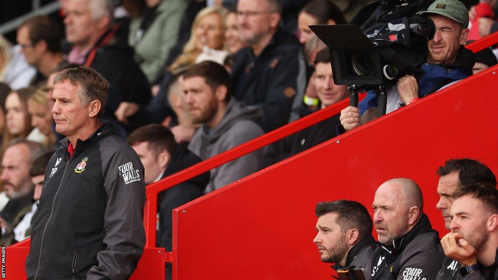 Wrexham manager Phil Parkinson looks on under the gaze of a film crew