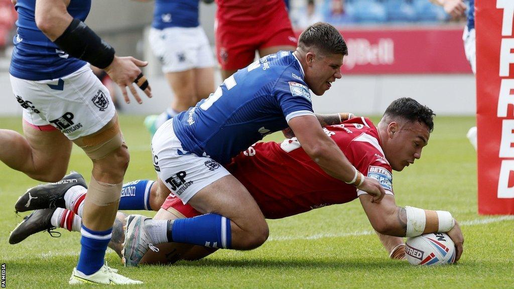 Salford Red's Tyler Dupree scores a try against Hull FC