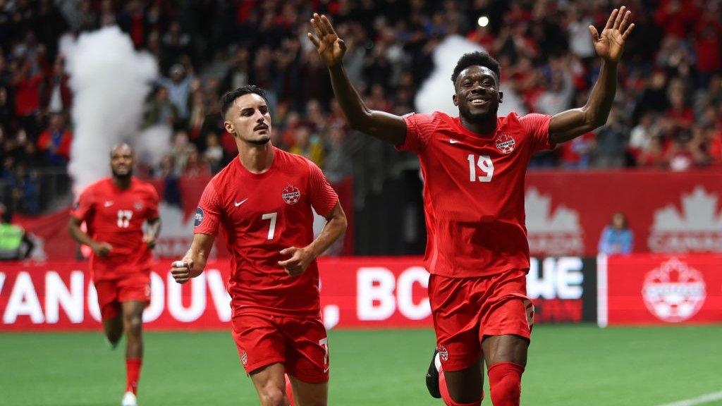 Alphonso Davies celebrating Canada's win against Curacao in June