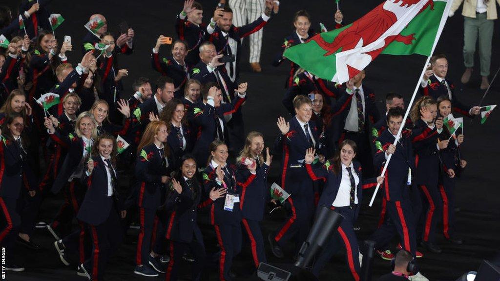 Geraint Thomas and Tesni Evans, Flag Bearers of Team Wales, lead the team out at the Commonwealth Games