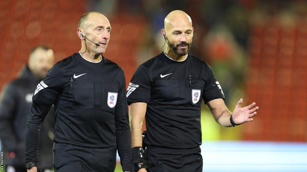 Referee Darren Drysdale walking off the pitch at full time