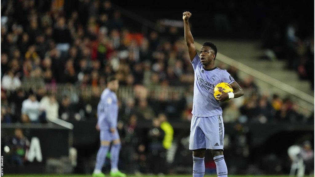 Vinicius Jr celebrating by raising his right fist into the air after scoring against Valencia