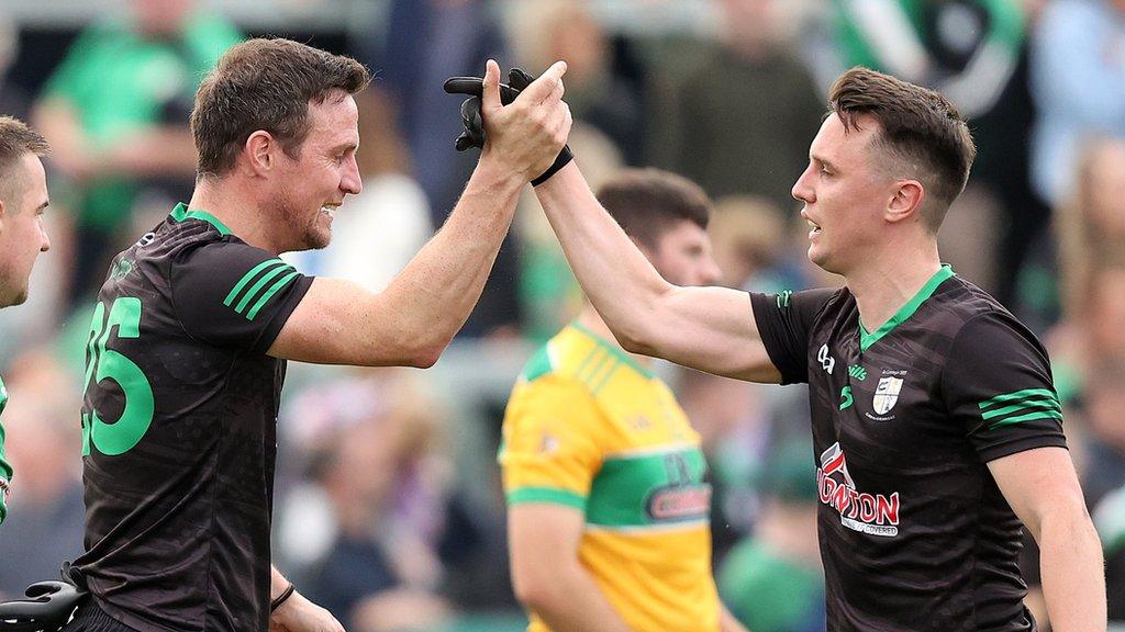 Michael McCann and Paul McCann celebrate Carigin's victory at the final whistle