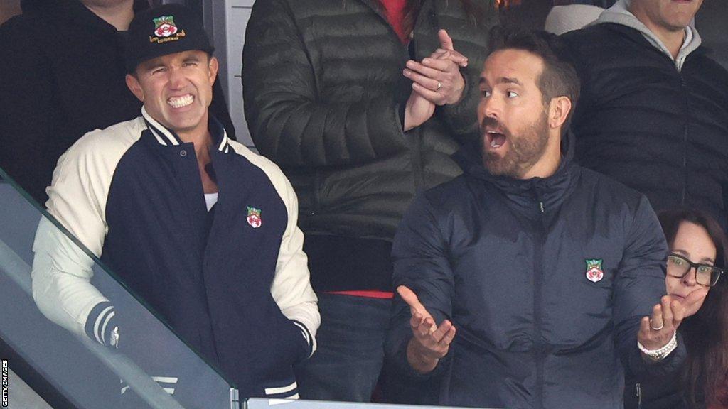 Wrexham owners Ryan Reynolds and Rob McElhenney react during the Vanarama National League fixture between Wrexham and Notts County