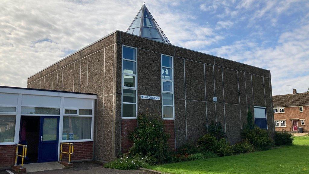 Square church building with glass pyramid roof