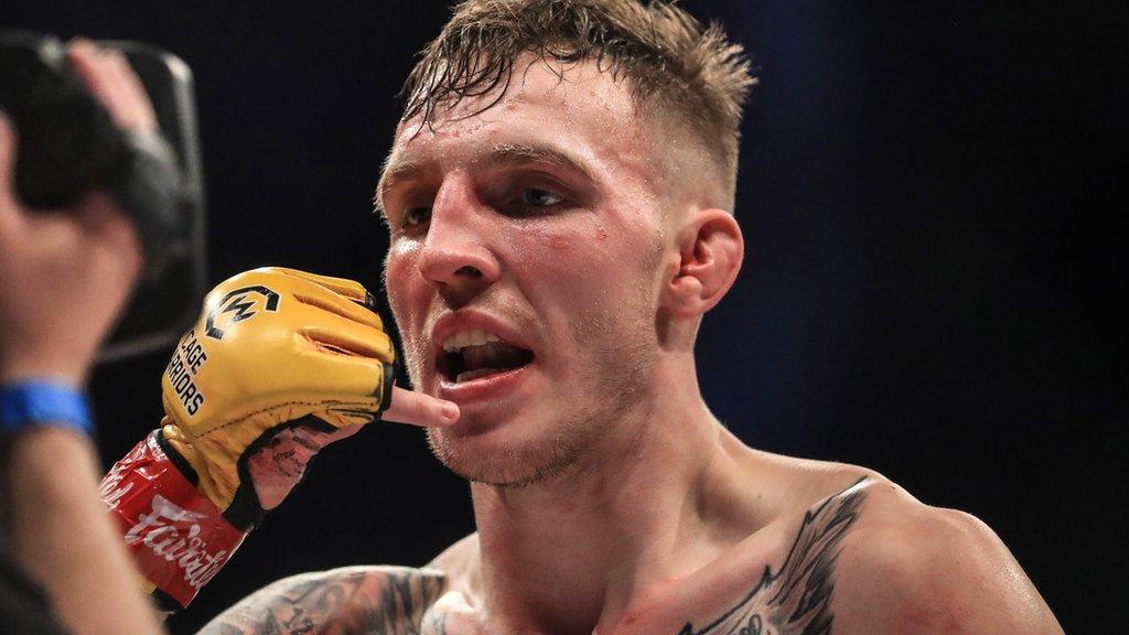 Rhys McKee celebrates after beating Jimmy Wallhead to retain his Cage Warriors welterweight title