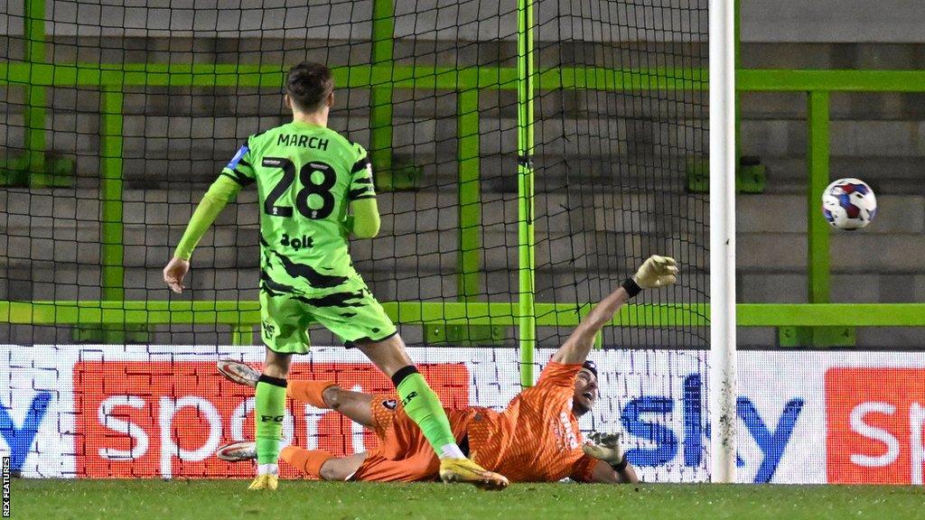 Cheltenham goalkeeper Luke Southwood saves Josh March's penalty for Forest Green