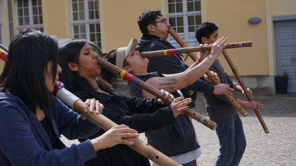 The group rehearsing in the palace grounds