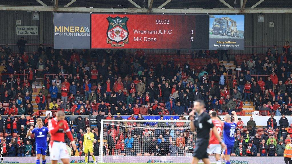 Scoreboard shows the final score as Wrexham 3-5 MK Dons