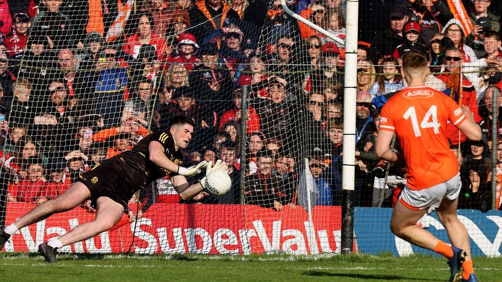 Derry keeper Odhran Lynch saves Rian O'Neill's penalty in the shootout