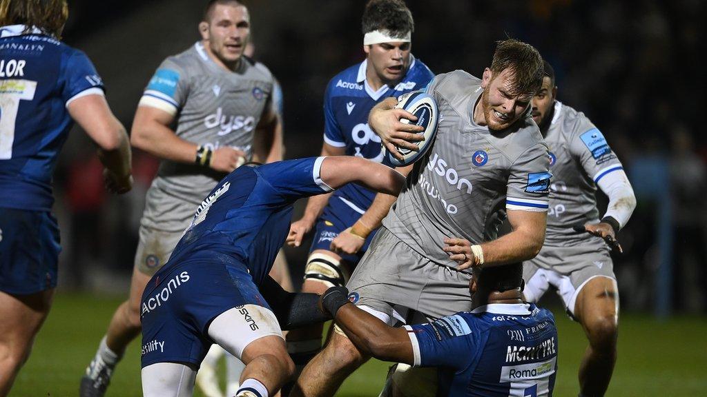 Bath's Josh McNally is tackled by Nick Schonert and Simon McIntyre